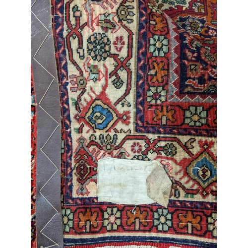 30 - A Persian rug with repeated boteh pelmets, flowers and geometric motifs, 158cm x 220cm
Location: G
I... 