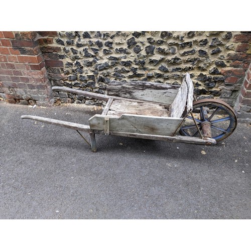 462 - An early 20th century wooden wheelbarrow with a wooden spoked wheel 
Location:G

Location:
If there ... 