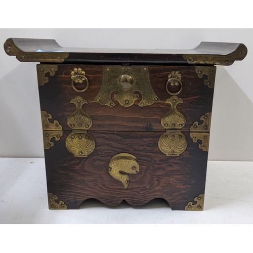 130 - A 20th century small Korean morijang chest with a flared top, ornate brass hinges supporting the fal... 