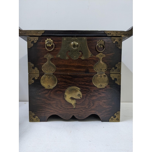 130 - A 20th century small Korean morijang chest with a flared top, ornate brass hinges supporting the fal... 