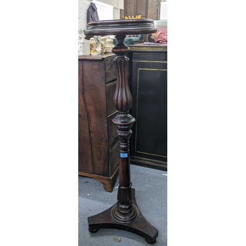 430 - An early 20th century mahogany pot/plant stand with a bordered stand with ovoid tubular and tapering... 