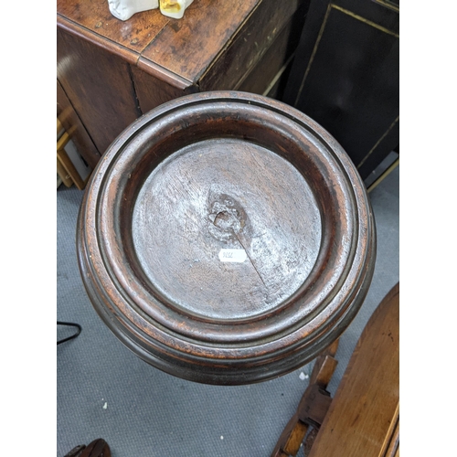 430 - An early 20th century mahogany pot/plant stand with a bordered stand with ovoid tubular and tapering... 