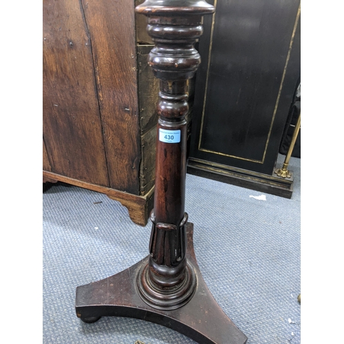 430 - An early 20th century mahogany pot/plant stand with a bordered stand with ovoid tubular and tapering... 