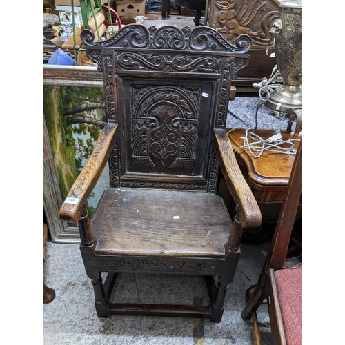 446 - A late 17th/early 18th century carved oak Wainscot chair, carved panel back, open arms, turned front... 