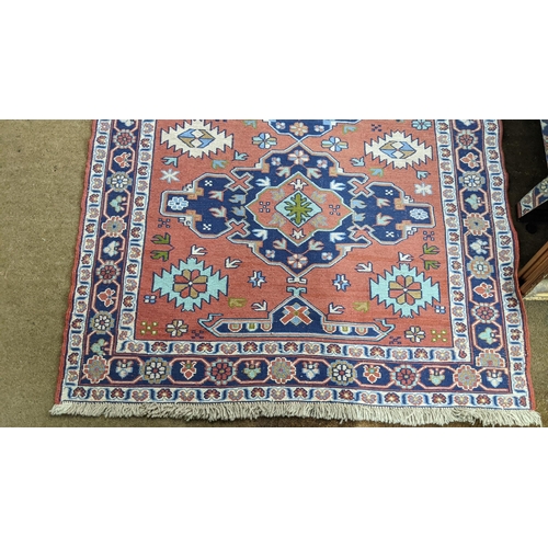 456 - A Turkish rug with geometric motifs on a red ground 167cm x 117cm Location:A2M
If there is no condit... 