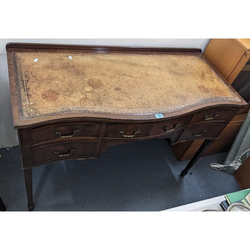 459 - Circa 1900, a mahogany serpentine fronted writing desk having a leather top and five drawers Locatio... 