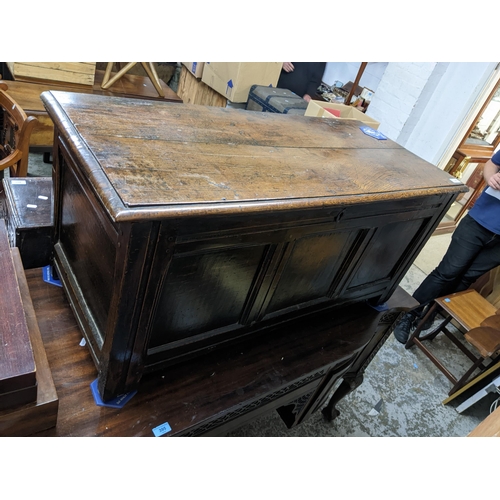 489 - A Georgian oak blanket chest, panelled front and sides, hinged top with moulded edge on short block ... 