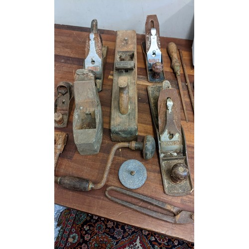 395 - A collection of vintage tools to include several wood working planes, a boxed auto braked winch, a s... 