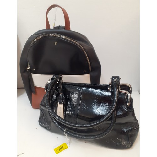 387 - Two modern fashion bags to include a Jasper Conran black patent handbag and a Fiorelli backpack. Loc... 