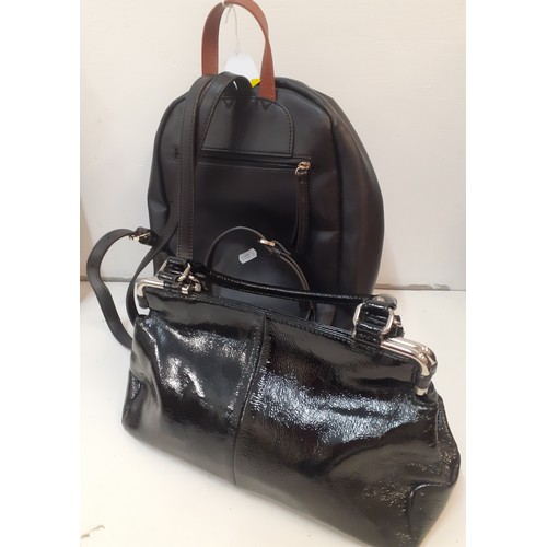 387 - Two modern fashion bags to include a Jasper Conran black patent handbag and a Fiorelli backpack. Loc... 