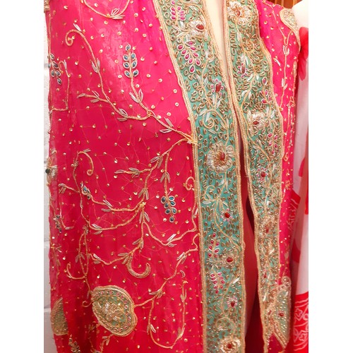 116 - A vintage embroidered sari/shawl having a pink ground with intricate gold metallic embroidery and be... 