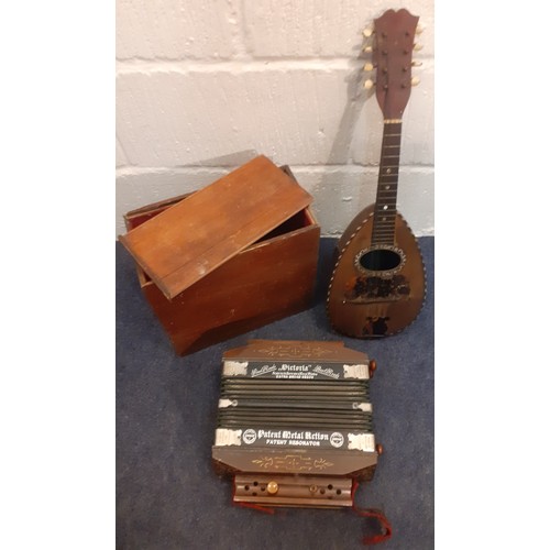 124 - A Phebe mandolin together with a German Kay & Co squeeze box housed in a mahogany box. Location: 1-2... 