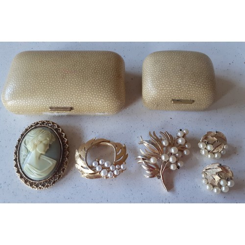 122 - A vintage  Trifari gold tone and pearl brooch and matching clip-on earrings together with 2 other br... 