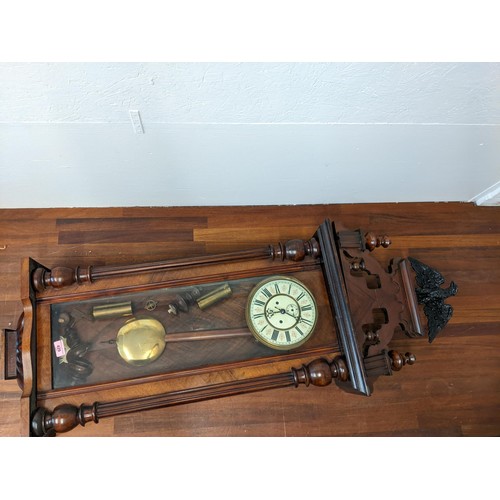 458 - A late 19th century walnut cased Vienna regulator style clock, surmounted by an eagle, with weights ... 