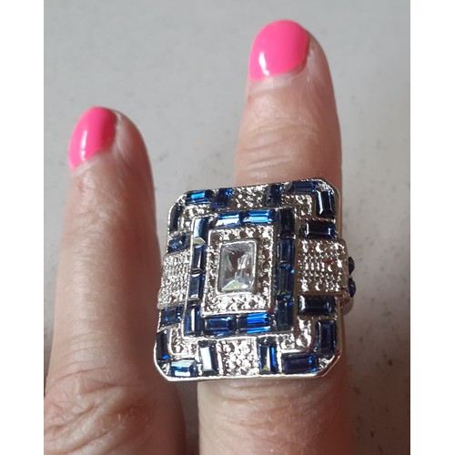 390 - An over-sized silver tone , blue and white crystal ring in the Art Deco style together with a silver... 