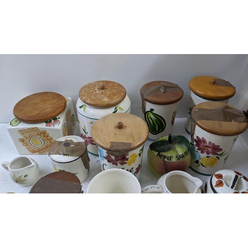 401 - A collection of Toni Raymond pottery to include lidded pots, money boxes fashioned as owl's, salt & ... 