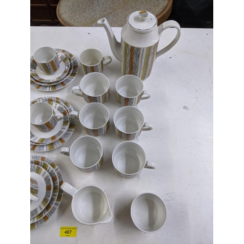 407 - A part Midwinter coffee set comprising of one coffee jug and lid, seven cups, six bigger cups, five ... 