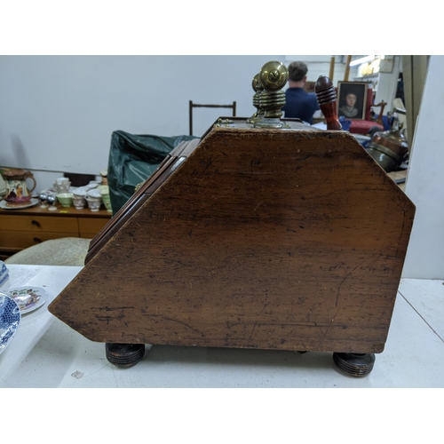 412 - A late Victorian oak coal scuttle with a brass handle, hinges, decorative plaque depicting a lions f... 