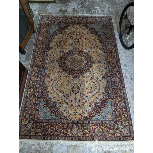 461 - A handwoven Persian rug, all over floral design with central motif, triple guard border and tasselle... 