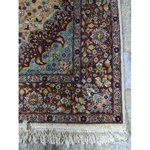 461 - A handwoven Persian rug, all over floral design with central motif, triple guard border and tasselle... 