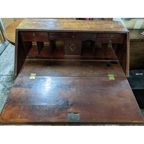 469 - A Georgian mahogany bureau, fall flap with pigeonhole and drawer interior, over a short drawer and t... 