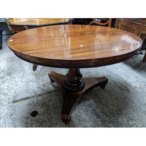 470 - A William IV rosewood breakfast table with gadroon decoration to the frieze apron, vase shaped and r... 