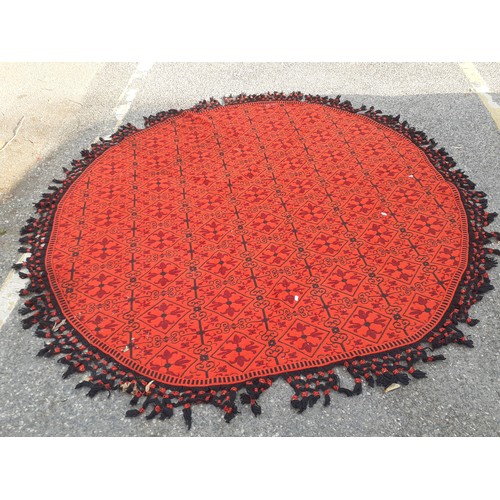 55 - A 1960's/70's Casa Pupo red and black oval woollen table covering/rug with black crotchet fringe. Lo... 