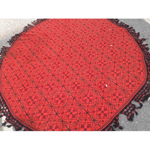 55 - A 1960's/70's Casa Pupo red and black oval woollen table covering/rug with black crotchet fringe. Lo... 