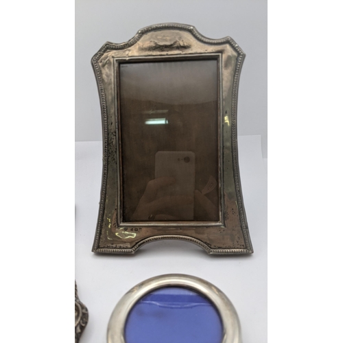 122 - Mixed silver items to include two silver photograph frames, a silver handled letter opener and shoe ... 