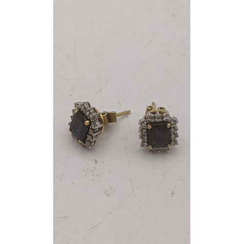 159 - A pair of yellow gold earrings set with emerald cut sapphires, surrounded by paste stones, having 18... 