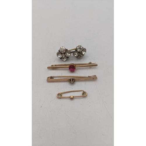 165 - Three gold brooches to include a 9ct gold stick pin set with a diamond 1.4g, along with a yellow gol... 