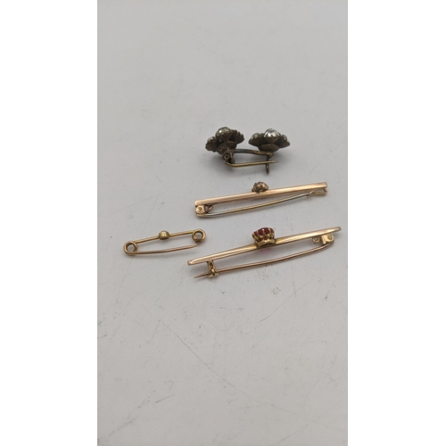 165 - Three gold brooches to include a 9ct gold stick pin set with a diamond 1.4g, along with a yellow gol... 