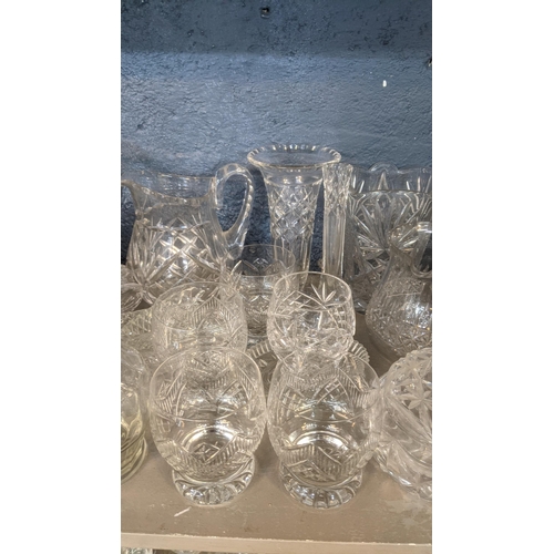 173 - A large quantity of mainly crystal cut glassware comprising of a variety of vases, fruit bowls, deca... 