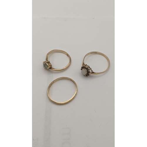 19 - Three 9ct gold rings to include a wedding band, cluster ring set with garnets and an opal A/F and on... 