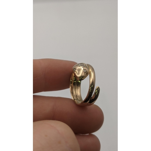 7 - A yellow gold ring fashioned as a snake set with diamonds, tested as 14ct gold, 3.9g
Location:RING
I... 