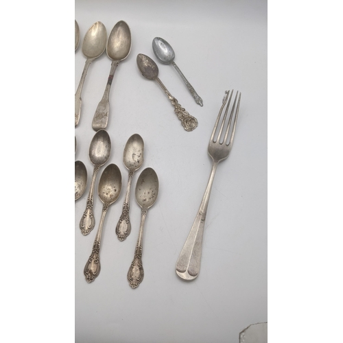 77 - Silver to include 5 fiddle pattern teaspoons, 6 sterling silver teaspoons and a fork total weight 26... 