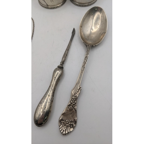 80 - Mixed silver to include a pair of napkin rings along with an ingot, a spoon with a floral terminal a... 