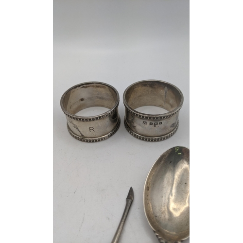 80 - Mixed silver to include a pair of napkin rings along with an ingot, a spoon with a floral terminal a... 