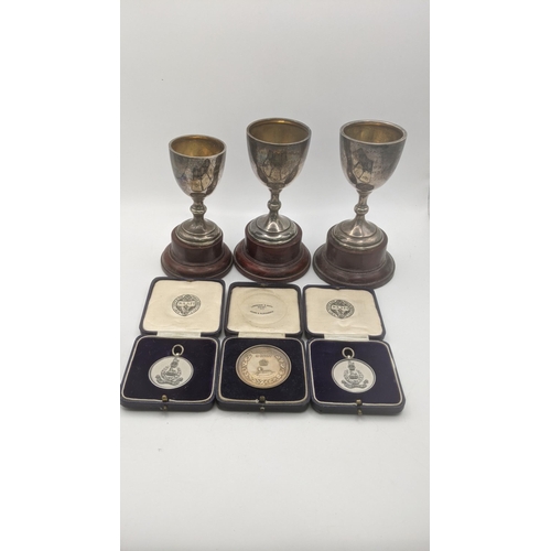 89 - Silver to include three trophies having gilt interior inscribed Malaya command athletic sports on wo... 