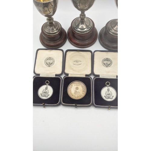 89 - Silver to include three trophies having gilt interior inscribed Malaya command athletic sports on wo... 