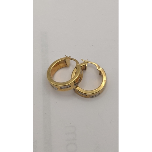 9 - A pair of two tone 9ct gold hoop earrings decorated with foot print impressions, total weight 2.8g
L... 