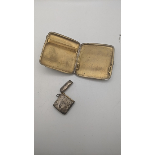 95 - A silver cigarette case having a floral engraved decoration, a central engraved initials with a gilt... 