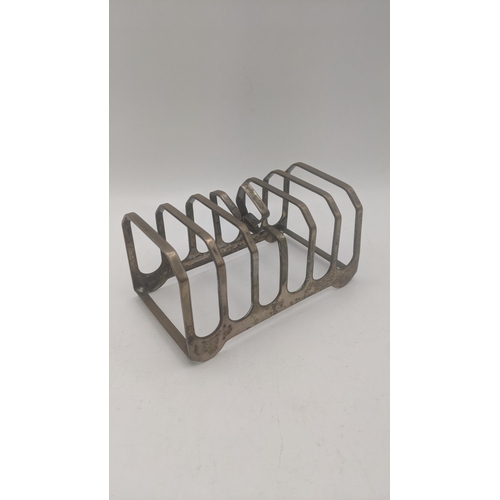 97 - Silver to include a toast rack A/F 122.g together with a silver fronted photo frame 
LocationA2T
If ... 