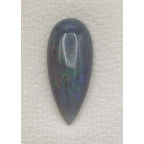 98 - A 4.7cts natural black with play of colour pear cabochon opal with AIG certificate of authenticity 
... 