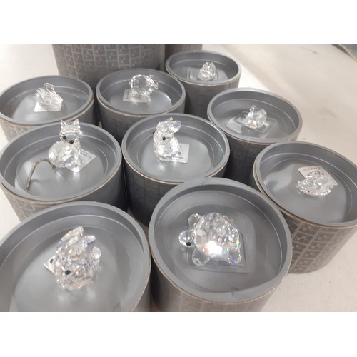 530 - A collection of Swarovski crystal animals and a pair of small candlesticks with boxes. Location:A1M
... 