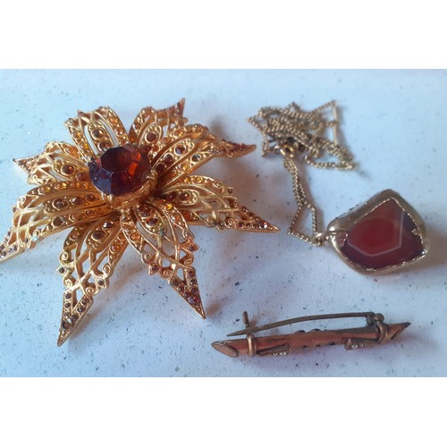 36 - A quantity of vintage costume jewellery to include a large Sphinx gold tone floral brooch with centr... 