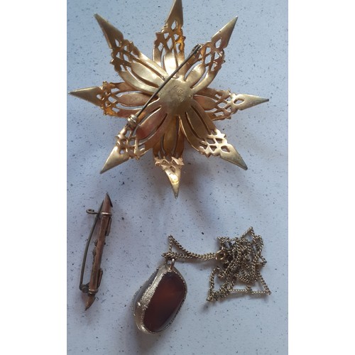 36 - A quantity of vintage costume jewellery to include a large Sphinx gold tone floral brooch with centr... 