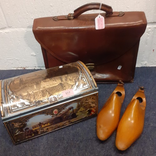 517 - A vintage Gianni Conti brown leather briefcase, a large Schmidt domed decorative tin and a pair of t... 