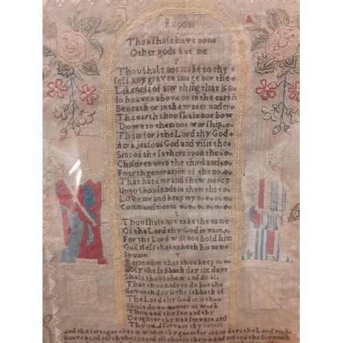 64 - A 1770 fine needlepoint on muslin sampler depicting religious verse from Exodus flanked by a male an... 