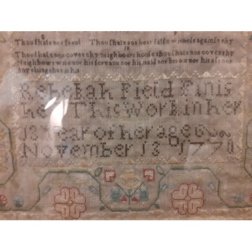 64 - A 1770 fine needlepoint on muslin sampler depicting religious verse from Exodus flanked by a male an... 